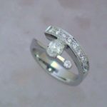 Bypass Ring With Oval Diamond and Single Row of Bright Set Round Accents - Diamond Fashion Rings - Dyke Vandenburgh Jewelers