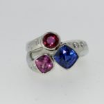 Shooting Star Blue Sapphire, Pink Sapphire, and Ruby Ring with Flush Set Diamonds - Dyke Vandenburgh Jewelers