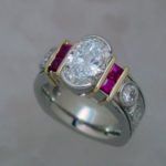 Two Tone Ring with Oval Diamond and Princess Cut Rubies - Dyke Vandenburgh Jewelers
